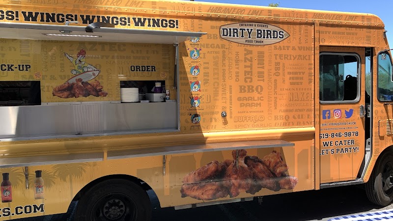 Side view of the orange Dirty Birds food truck and its serving window